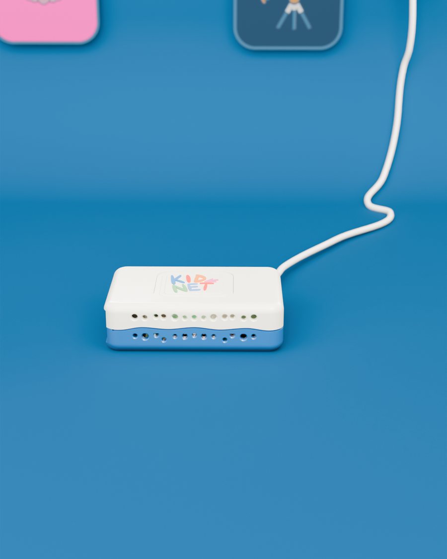 The KidNet box on a blue table with its cable running off to a wall socket.