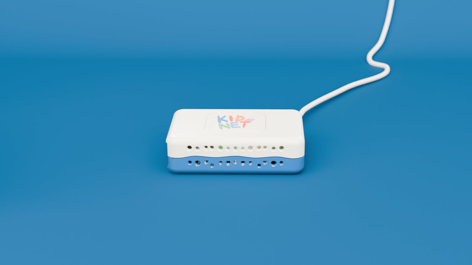 The KidNet box on a blue table with its cable running off to a wall socket.